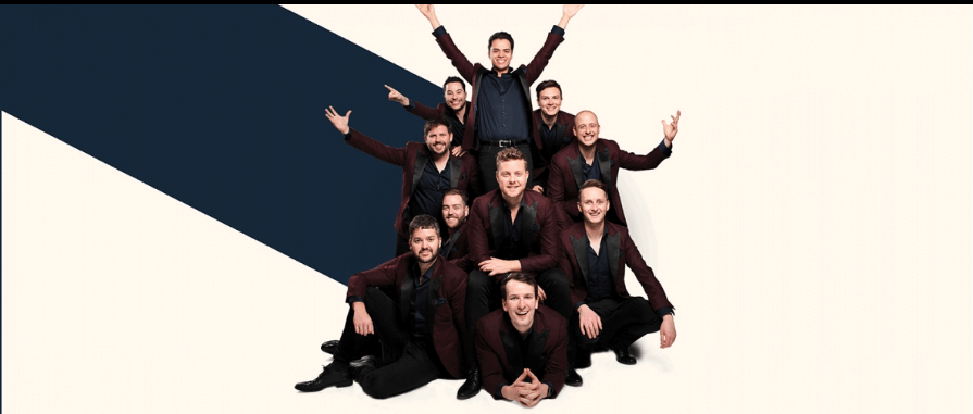 Ten men in suits smiling.